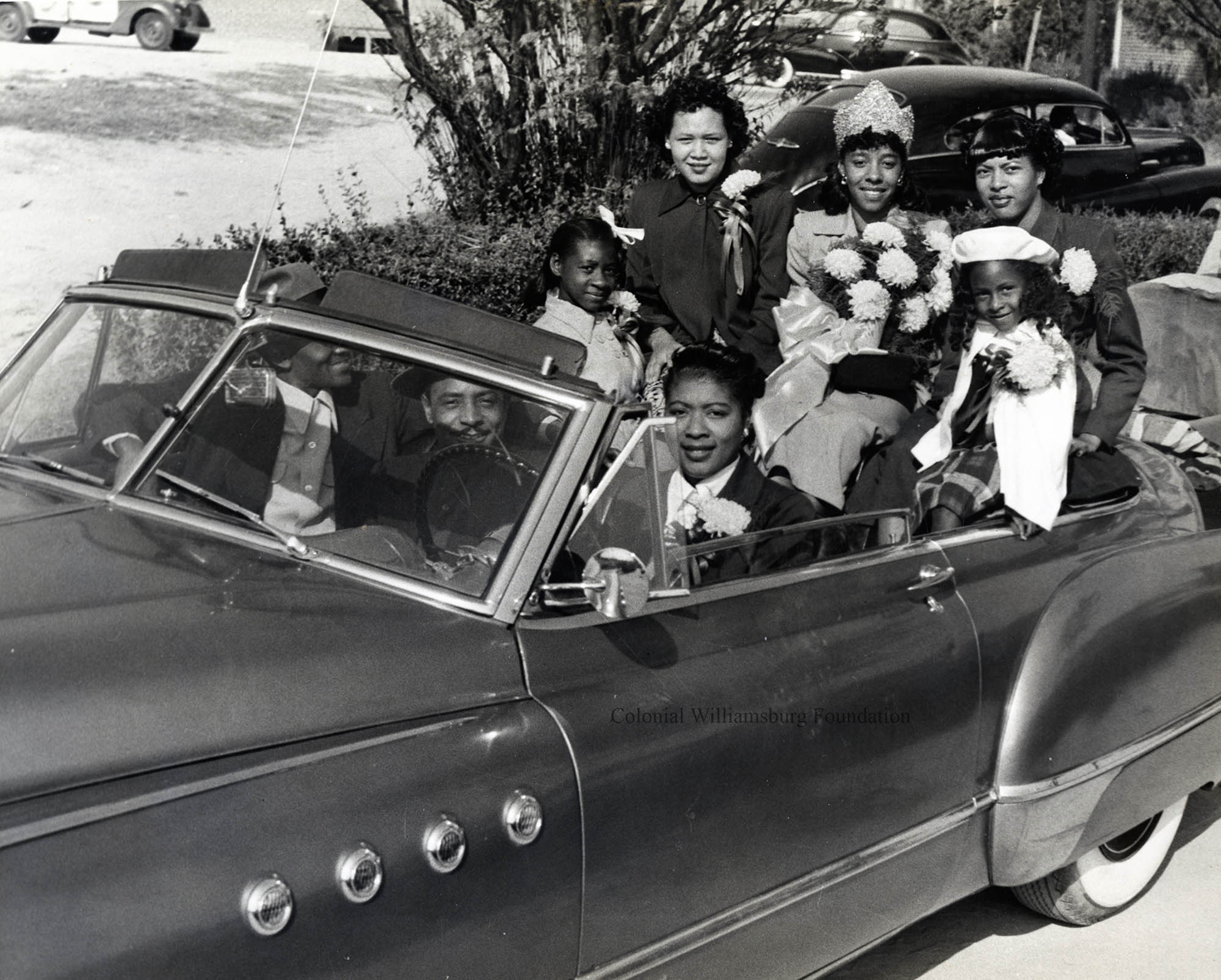 Homecoming Queen And Her Court Riding In An Automobile Possibly As Part Of A Parade 
